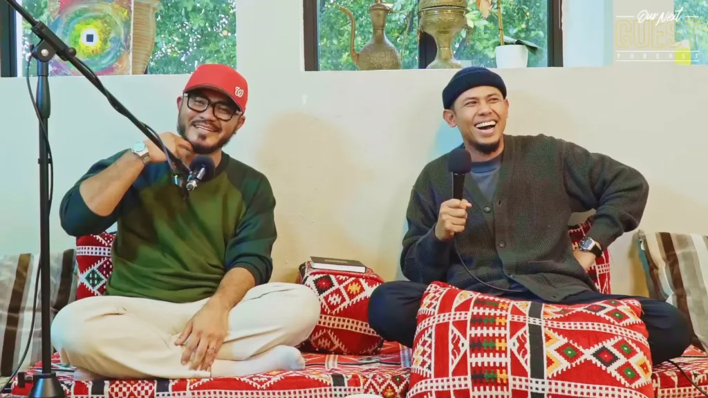 two men sitting and laughing