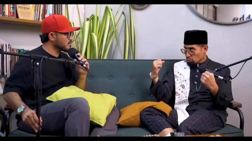 a man talking to another man on a couch